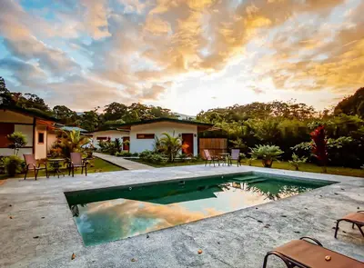 a swimming pool in the backyard of a house at Bambura Bahia Villas in Uvita