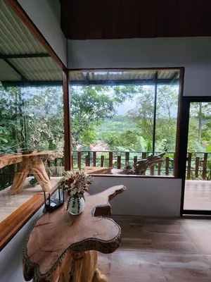 a large room with a table and a large window at Montana Log Cabin in Rivas