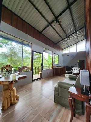a living room with a couch and a table at Montana Log Cabin in Rivas