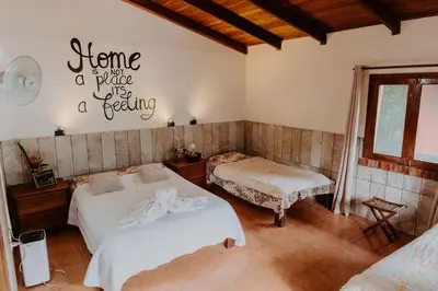 a bedroom with two beds and a sign on the wall at Lodge Mirador - Great Swimming pool - Kitchen - BBQ - Netflix in Tajo Alto