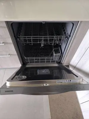 an empty dishwasher in a kitchen with its door open at Ocean View steps to the beach in Punta Leona