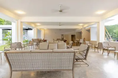 a living room with chairs and a couch and tables at Ocean View steps to the beach in Punta Leona