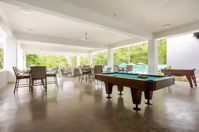a large room with a pool table and chairs at Ocean View steps to the beach in Punta Leona