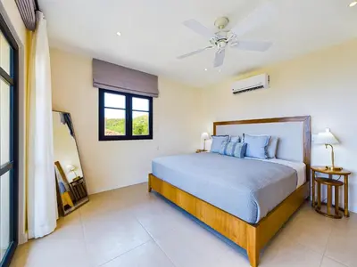 a bedroom with a bed and a ceiling fan at Casa Luna At Las Catalinas in Playa Danta