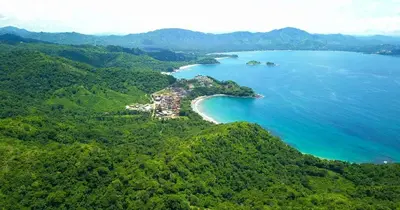 an island in the middle of a body of water at Casa Luna At Las Catalinas in Playa Danta