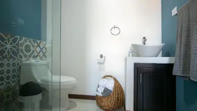 a bathroom with a toilet and a sink at Villa Palmera-Fortuna in Fortuna