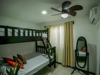 a bedroom with two bunk beds and a ceiling fan at Villa Palmera-Fortuna in Fortuna