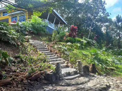 a set of stone steps leading up to a house at Cuki House in Quesada