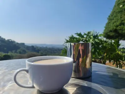 a cup of coffee sitting on top of a table at Hotel Bar Restaurante IL Rifugio in Poás