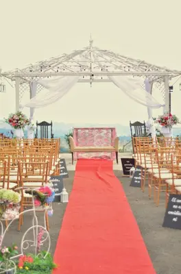 a red carpeted aisle with chairs and a marquee at Hotel Bar Restaurante IL Rifugio in Poás