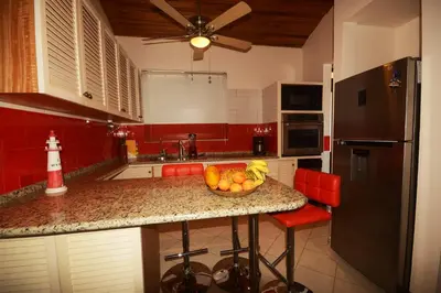 a kitchen with a bowl of fruit on a counter at The Lighthouse Ocotal in Coco