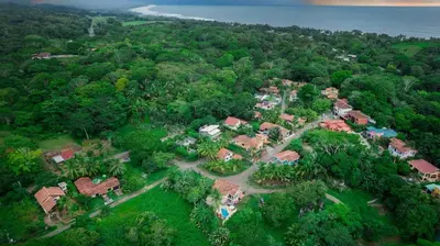an aerial view of a house in a forest at Villa Cascada by Vacation Pura Vida in Esterillos
