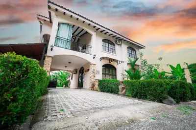 a large white house with a driveway at Villa Cascada by Vacation Pura Vida in Esterillos