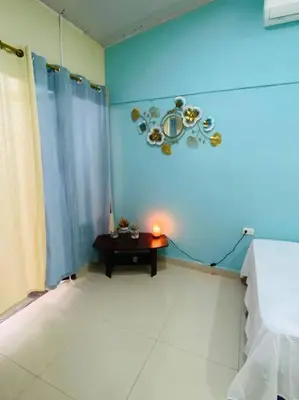 a room with a table and a blue wall at Brand New Descanso del Perezoso in Manuel Antonio