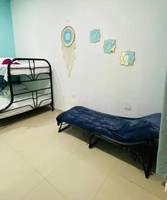 a hospital room with a bed and a wall at Brand New Descanso del Perezoso in Manuel Antonio