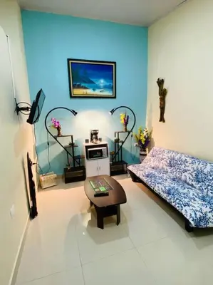 a living room with a bed and a table in it at Brand New Descanso del Perezoso in Manuel Antonio