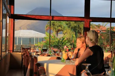 two women sitting at a table with a view of a mountain at Hotel Linda Vista in Fortuna