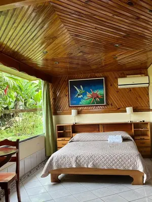 a bedroom with a bed in a wooden ceiling at Hotel Linda Vista in Fortuna