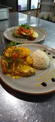 two plates of food on a table with rice at Hotel Linda Vista in Fortuna