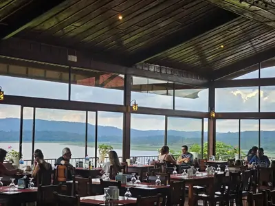 a group of people sitting at tables in a restaurant at Hotel Linda Vista in Fortuna