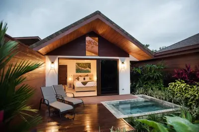 a room with a bed and a patio with chairs at Fortuna Retreat in Fortuna