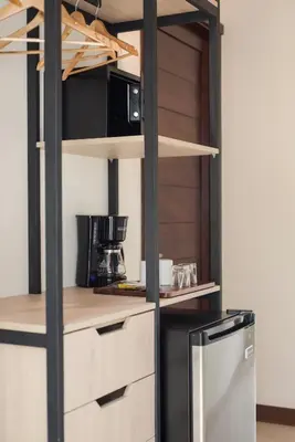 a kitchen with white cabinets and a black refrigerator at Fortuna Retreat in Fortuna