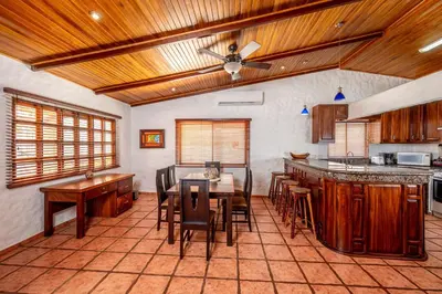 a kitchen with a table and chairs in a room at BP Surf Hotel in Playa Grande