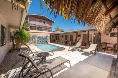 a patio with chairs and a swimming pool at BP Surf Hotel in Playa Grande