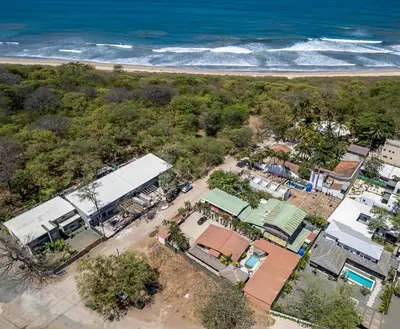 an overhead view of a small town next to the beach at BP Surf Hotel in Playa Grande