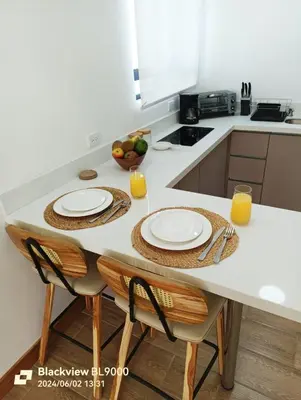 a kitchen with a table with two plates on it at Valu in Puntarenas