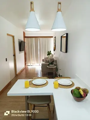 a white kitchen with two plates on a counter at Valu in Puntarenas