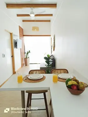 a kitchen with a table with a bowl of fruit on it at Valu in Puntarenas