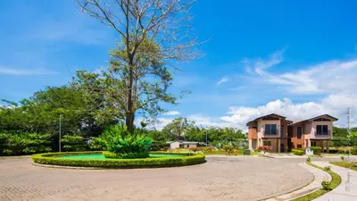a roundabout with a tree in the middle of a street at Ciudad del Mar 126 condo in Jacó