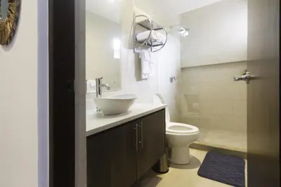 a bathroom with a sink and a toilet at Ciudad del Mar 126 condo in Jacó