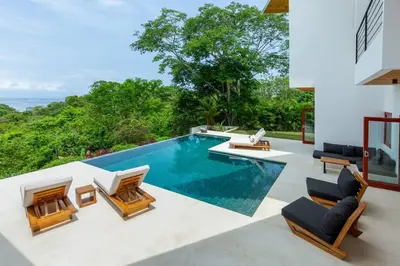 a swimming pool in a villa with a view at Elegant Ocean View Villa Serena in Cóbano