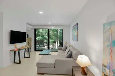 a living room with a couch and a tv at Arcadia Condo In Místico, Playa Hermosa in Playa Hermosa