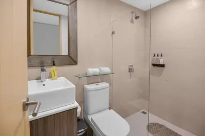 a bathroom with a toilet and a sink and a shower at Arcadia Condo In Místico, Playa Hermosa in Playa Hermosa