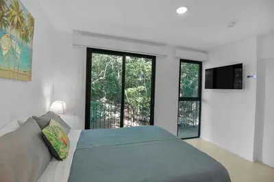 a bedroom with a bed and a large window at Arcadia Condo In Místico, Playa Hermosa in Playa Hermosa