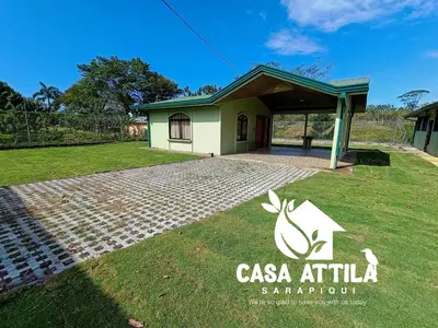 a house with a sign in front of it at Casa Attila Sarapiquí in Sarapiquí