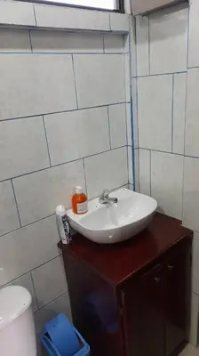 a bathroom with a sink and a toilet at Casa Attila Sarapiquí in Sarapiquí
