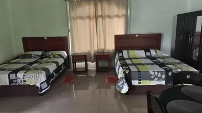 two beds sitting next to each other in a room at Casa Attila Sarapiquí in Sarapiquí