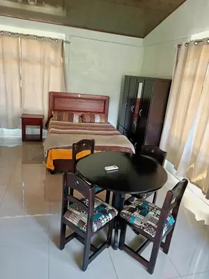 a room with a table and chairs and a bed at Casa Attila Sarapiquí in Sarapiquí