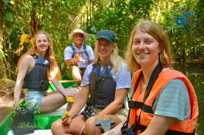 a group of people sitting on a raft at Chilamate Room 2 in Tortuguero