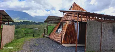 a small building with a mountain in the background at Vistas Paraiso San Carlos in Venecia