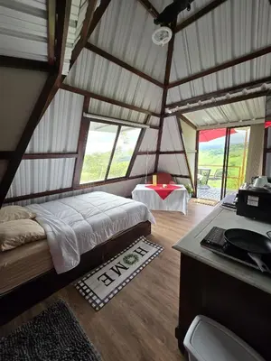 a bedroom with a bed in a room with windows at Vistas Paraiso San Carlos in Venecia