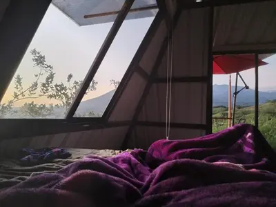 a bed in a room with a large window at Vistas Paraiso San Carlos in Venecia