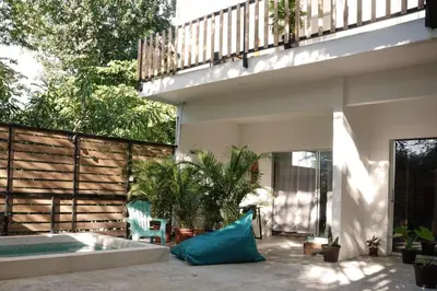 a patio with a swimming pool and a house at Casa IGUANA in Santa Teresa Beach