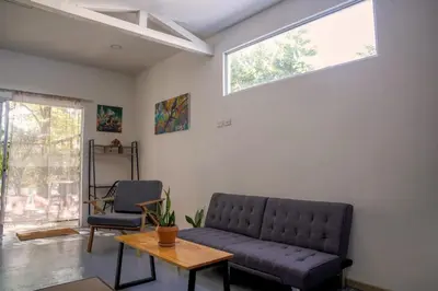 a living room with a couch and a table at Casa IGUANA in Santa Teresa Beach