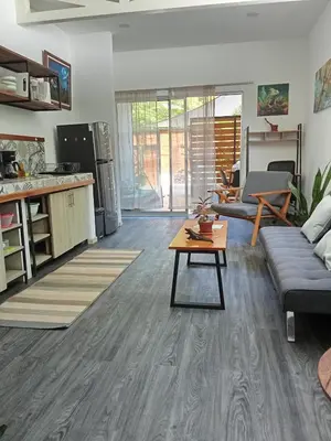 a living room with a couch and a table at Casa IGUANA in Santa Teresa Beach