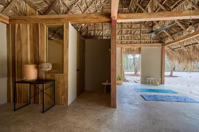 a living room with a wooden ceiling and a hallway at SURÁ Playa Negra in Playa Negra